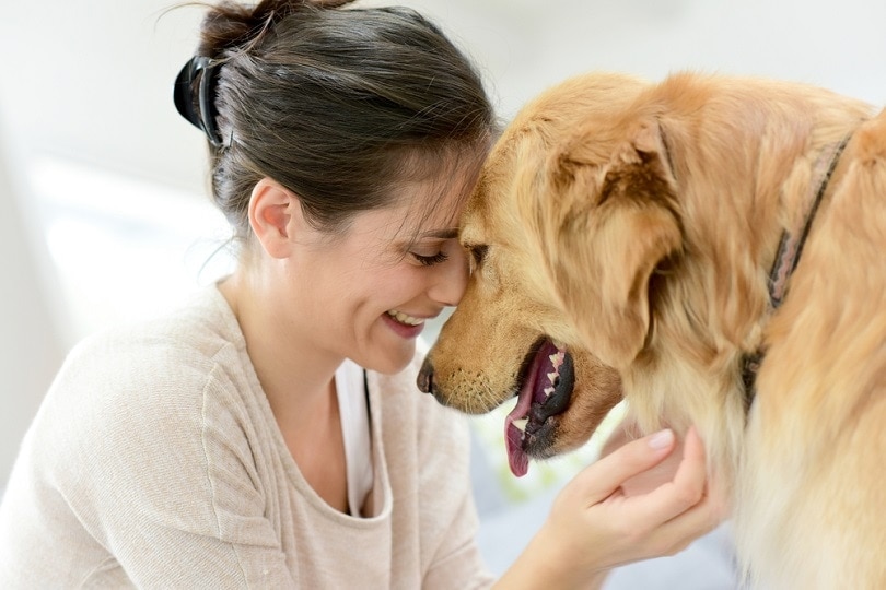 Portrait of woman with dog goodluz shutterstock